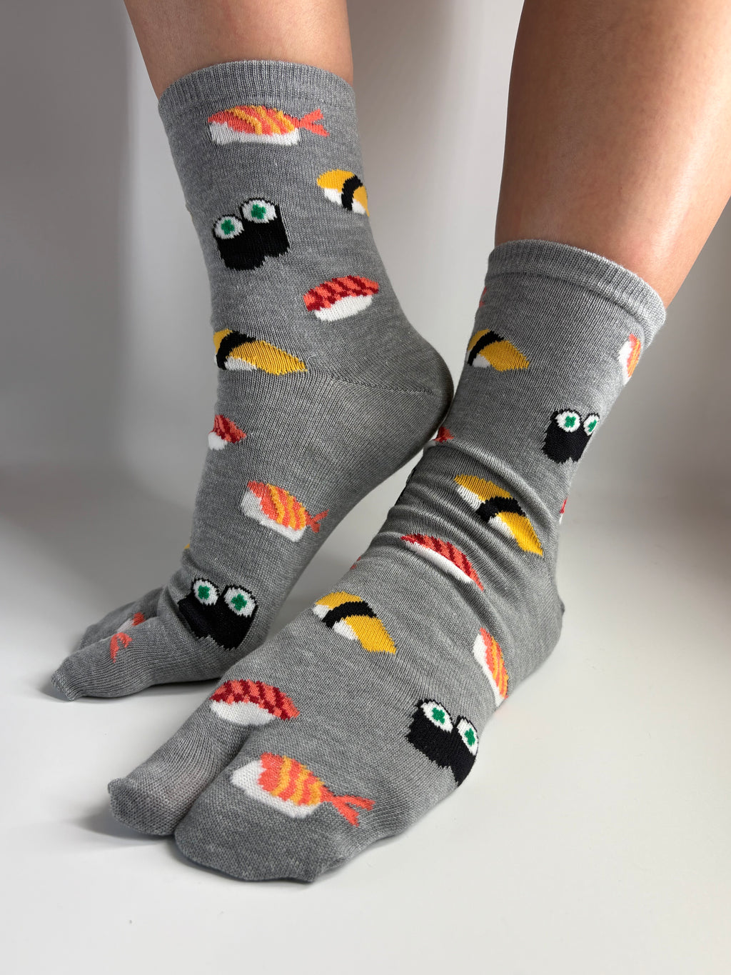 Grey sushi print tabi socks being shown from a diagonal side