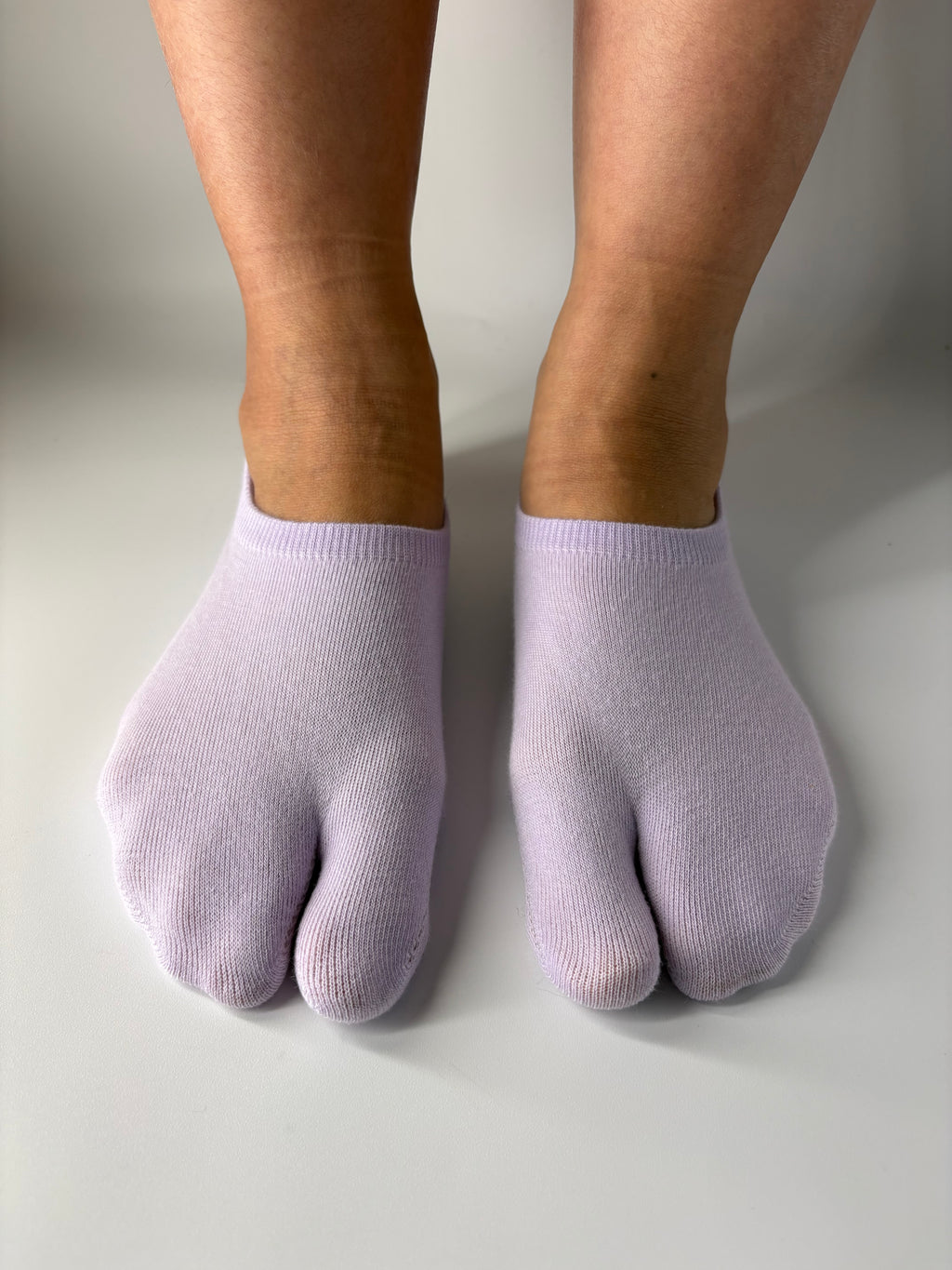 Tabi Co. lavender split-toe cotton low show socks in a solid pastel purple, worn on feet