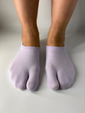 Tabi Co. lavender split-toe cotton low show socks in a solid pastel purple, worn on feet