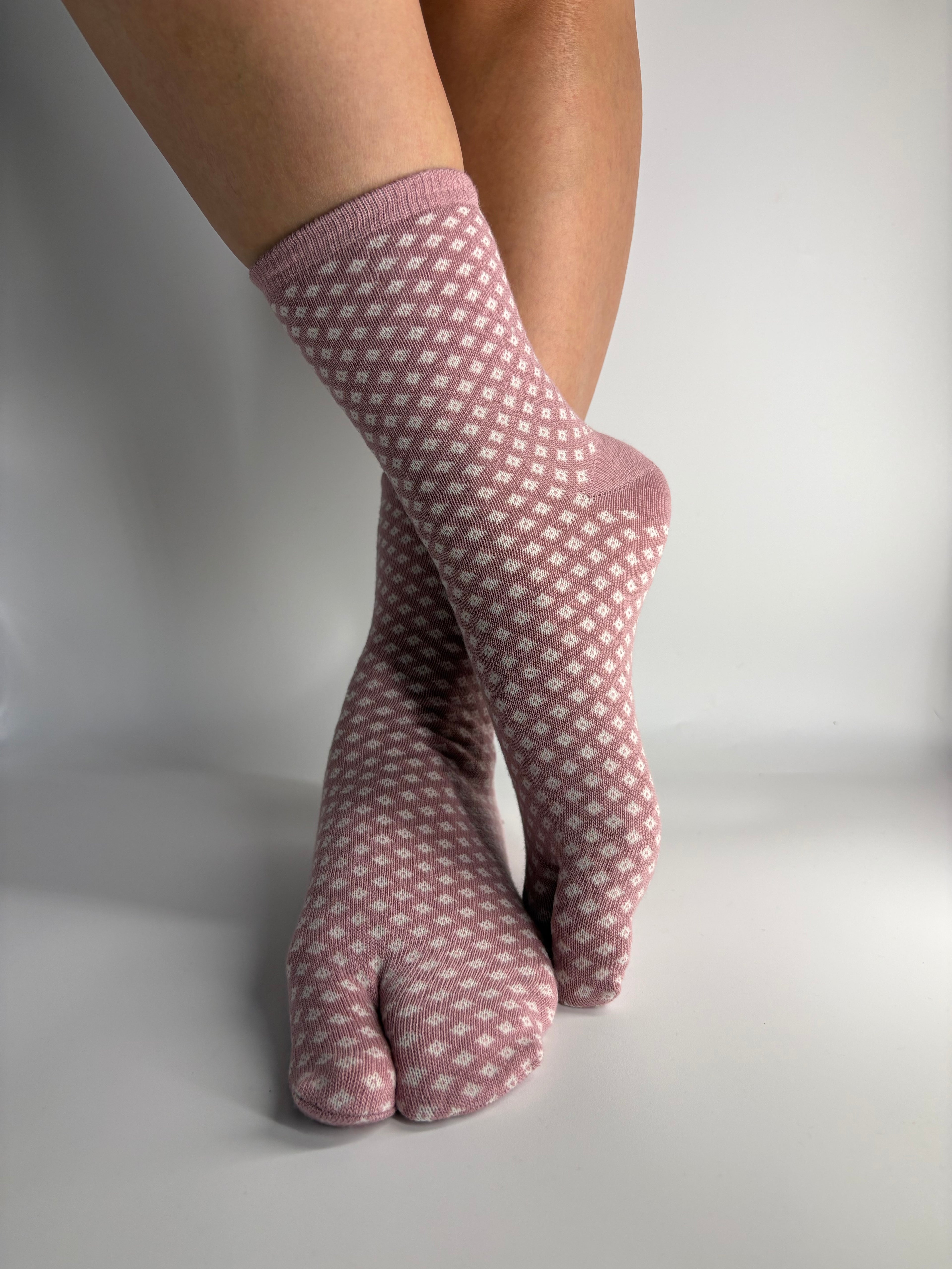 pink hishi diamond print socks traditional japanese pattern on split toe tabi socks made of cotton, standing on a white background