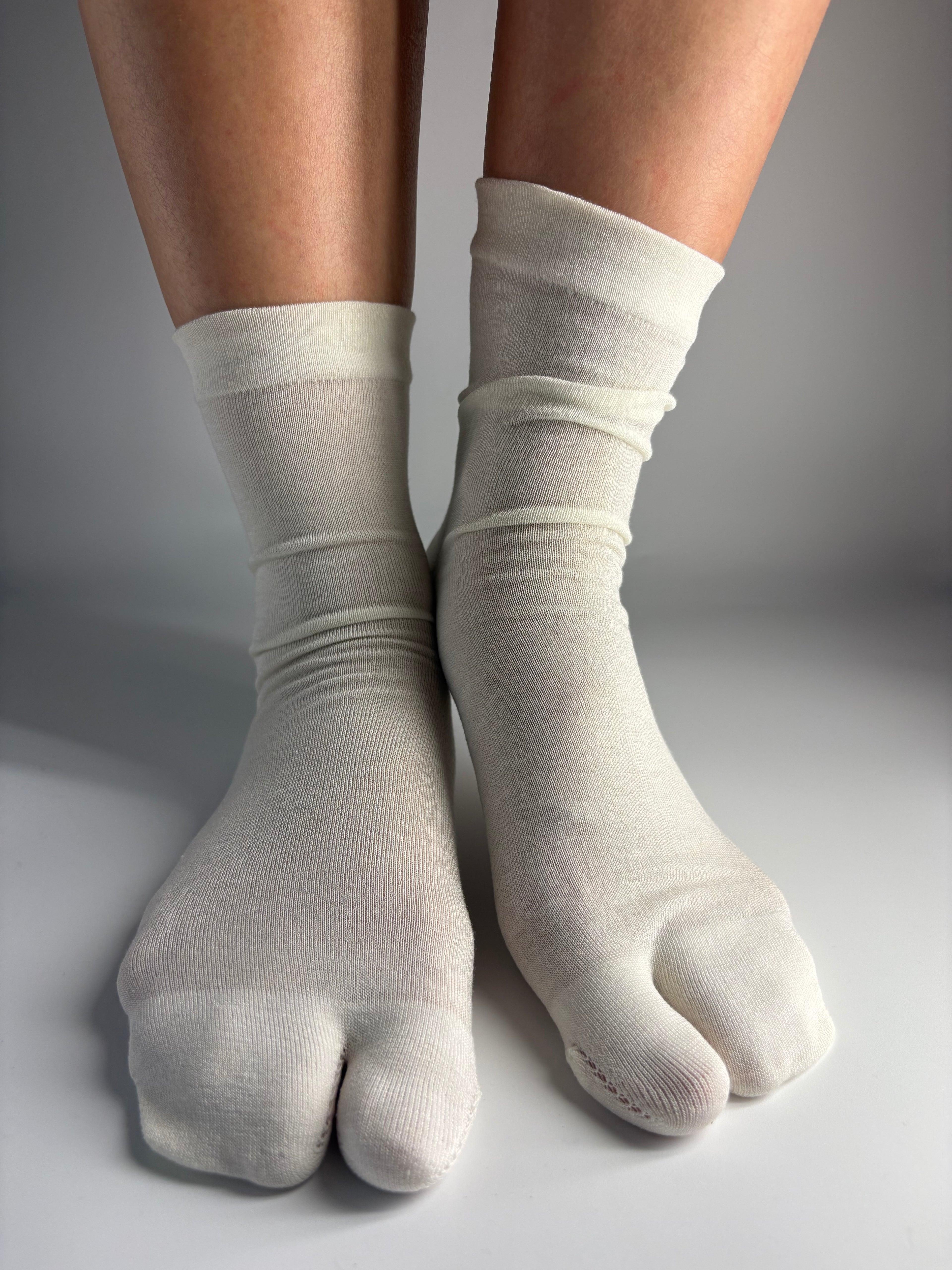 Sheer cream mulberry silk blend split-toe tabi socks in crew length — quiet luxury sock inspiration from Tabi Co.