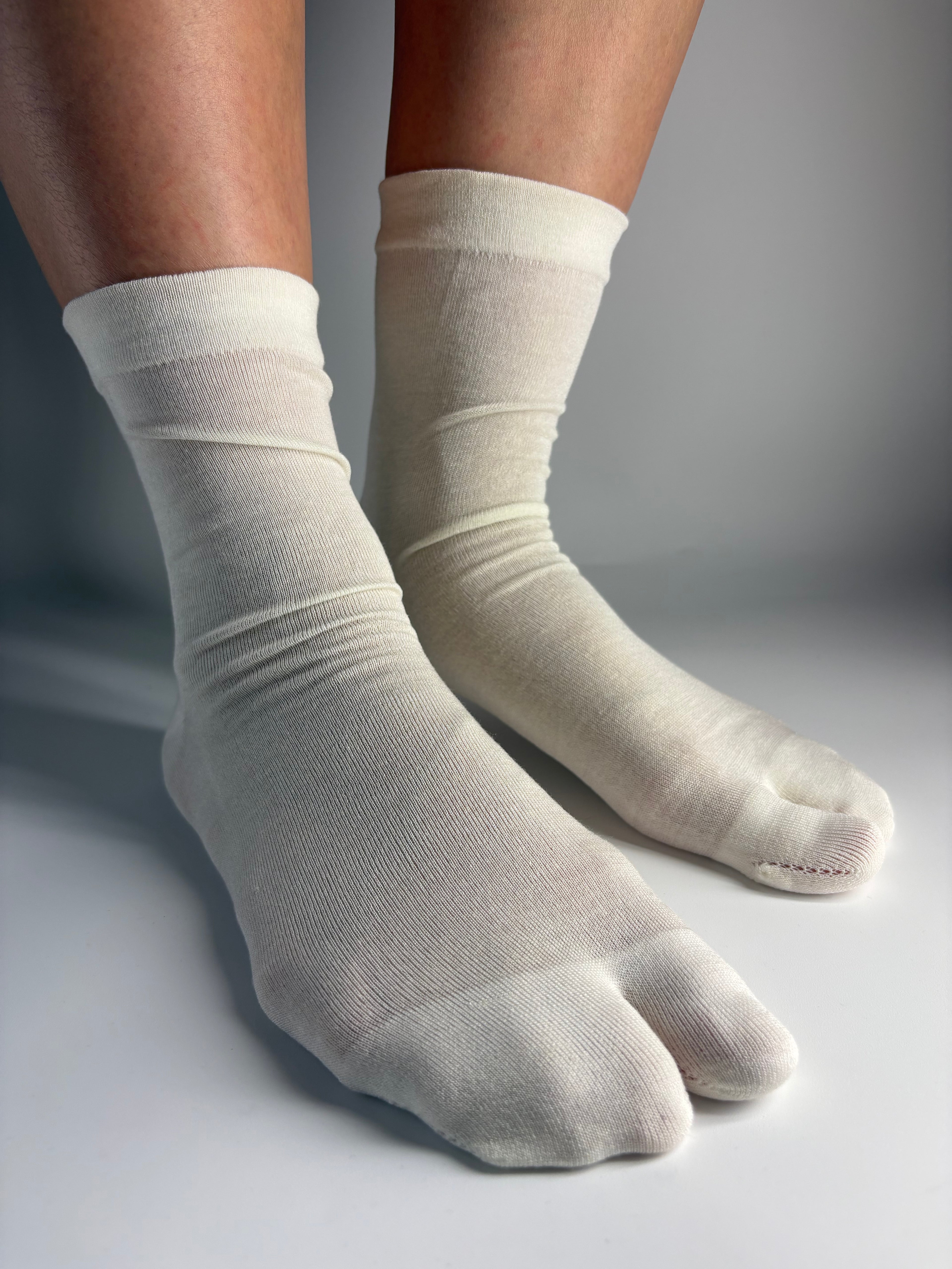 Sheer cream silk blend tabi socks with a split-toe design — Tabi Co. UK.