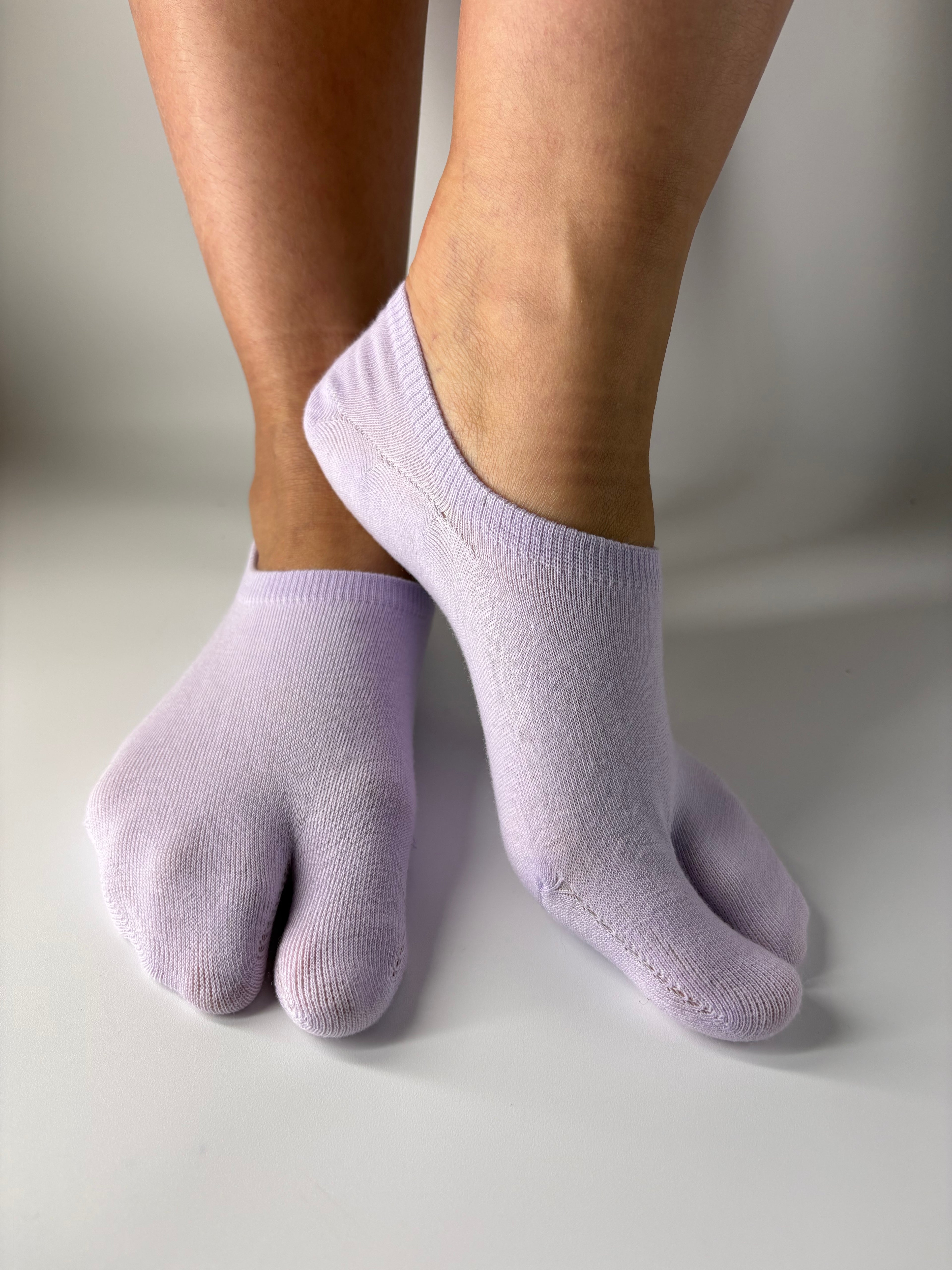 Tabi Co. lavender split-toe cotton no-show socks in a solid pastel purple, worn on feet